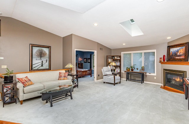 706 Pershing Ave N, New Prague, MN 56071 - living area featuring lofted ceiling, a skylight, light carpet, baseboards, and a glass covered fireplace