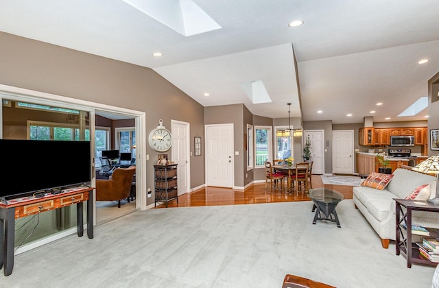 706 Pershing Ave N, New Prague, MN 56071 - living room featuring a skylight, recessed lighting, light wood-type flooring, vaulted ceiling, and baseboards