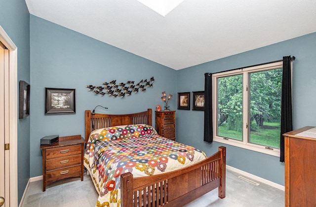 706 Pershing Ave N, New Prague, MN 56071 - bedroom with light colored carpet, vaulted ceiling, and baseboards