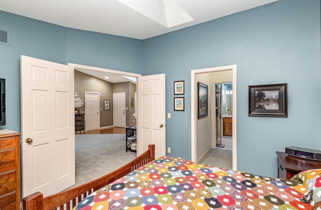 706 Pershing Ave N, New Prague, MN 56071 - bedroom featuring a skylight, carpet, baseboards, and ensuite bathroom