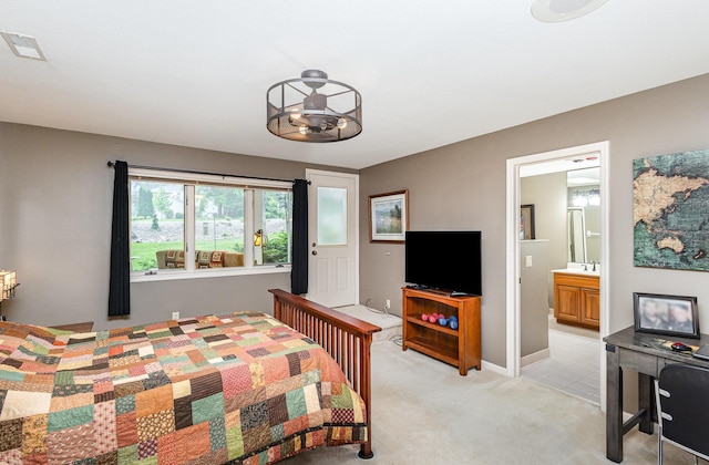 706 Pershing Ave N, New Prague, MN 56071 - bedroom with light carpet, ensuite bath, and baseboards