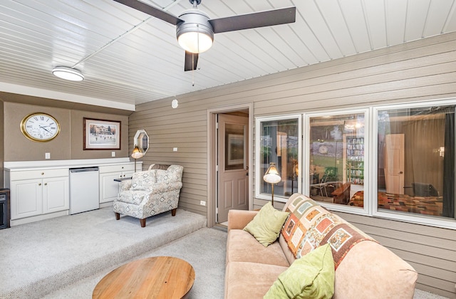 706 Pershing Ave N, New Prague, MN 56071 - living room with wood walls, light carpet, and ceiling fan