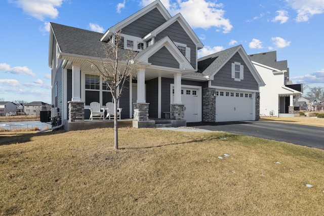 12946 Jewell Cir, Blaine, MN 55449 - craftsman inspired home with a porch, driveway, a front lawn, and stone siding