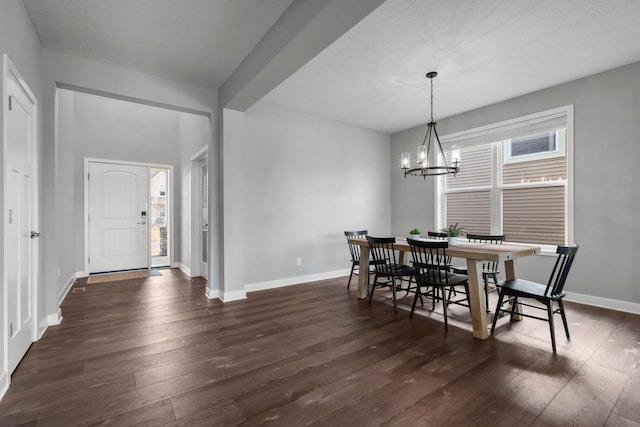 12946 Jewell Cir, Blaine, MN 55449 - dining area with dark wood-style flooring, a chandelier, and baseboards