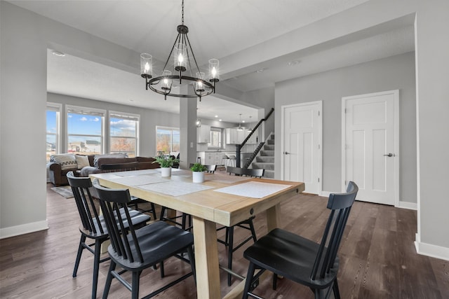 12946 Jewell Cir, Blaine, MN 55449 - dining room featuring a chandelier, baseboards, stairs, and wood finished floors