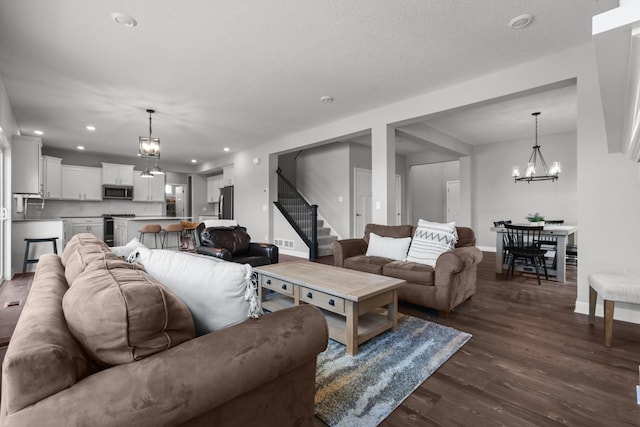 12946 Jewell Cir, Blaine, MN 55449 - living area featuring a chandelier, stairway, dark wood finished floors, baseboards, and recessed lighting