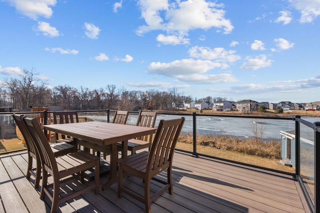 12946 Jewell Cir, Blaine, MN 55449 - wooden deck featuring outdoor dining space, a residential view, and a water view