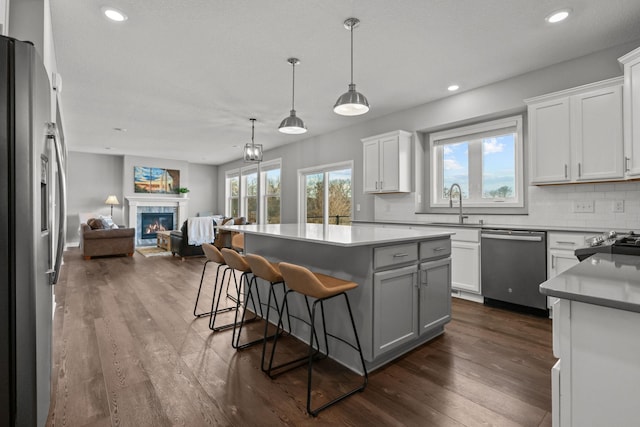 12946 Jewell Cir, Blaine, MN 55449 - kitchen featuring stainless steel appliances, open floor plan, a kitchen island, backsplash, and recessed lighting