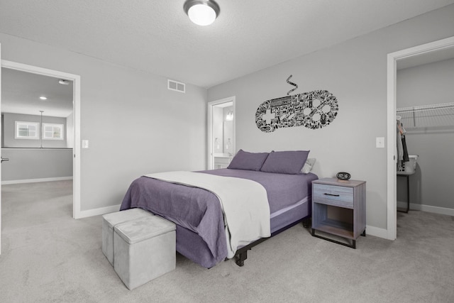 12946 Jewell Cir, Blaine, MN 55449 - bedroom featuring carpet, a walk in closet, and baseboards