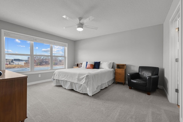 12946 Jewell Cir, Blaine, MN 55449 - bedroom featuring light carpet, baseboards, a textured ceiling, and a ceiling fan