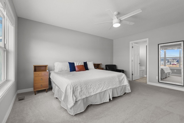 12946 Jewell Cir, Blaine, MN 55449 - bedroom with light colored carpet, multiple windows, baseboards, and ceiling fan