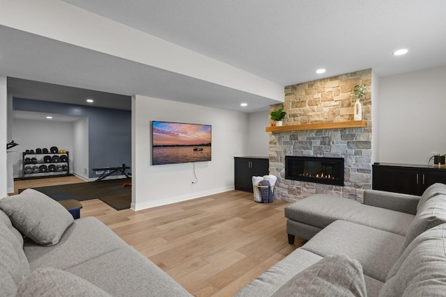 12946 Jewell Cir, Blaine, MN 55449 - living area with light wood-type flooring, a stone fireplace, baseboards, and recessed lighting