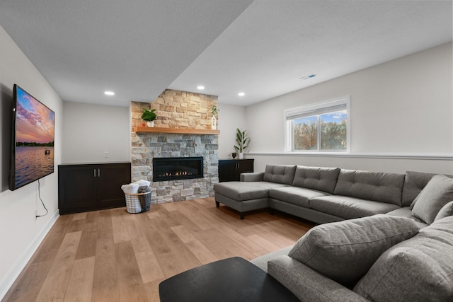12946 Jewell Cir, Blaine, MN 55449 - living area with wood finished floors, a stone fireplace, and recessed lighting