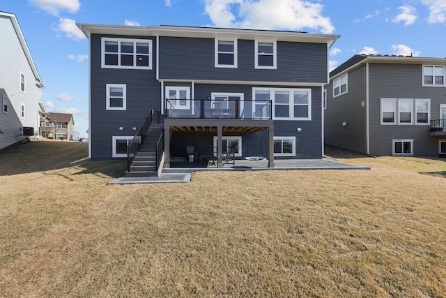 12946 Jewell Cir, Blaine, MN 55449 - rear view of house with stairway, a patio, a deck, and a yard