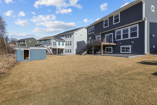 12946 Jewell Cir, Blaine, MN 55449 - rear view of house featuring stairway, a residential view, a wooden deck, and a lawn