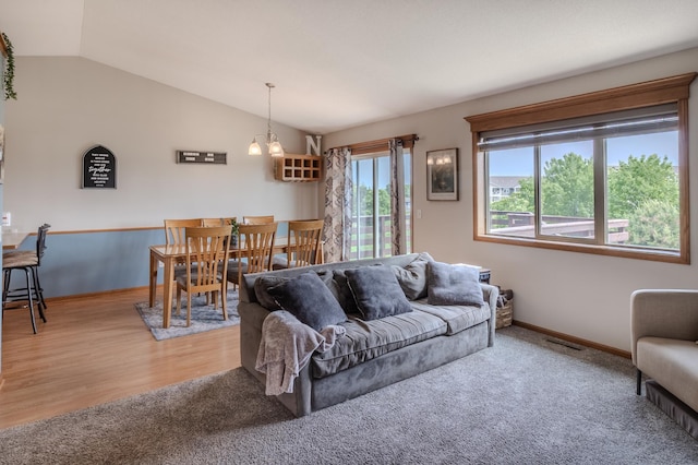 250 18th Ave SE, Saint Joseph, MN 56374 - living area featuring vaulted ceiling, baseboards, a chandelier, and wood finished floors