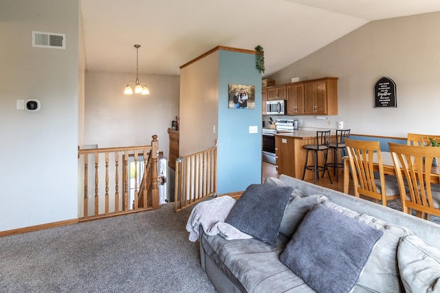 250 18th Ave SE, Saint Joseph, MN 56374 - living area with vaulted ceiling, carpet floors, baseboards, and a chandelier