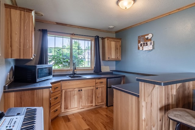 250 18th Ave SE, Saint Joseph, MN 56374 - kitchen with stainless steel microwave, a sink, dark countertops, crown molding, and a kitchen breakfast bar