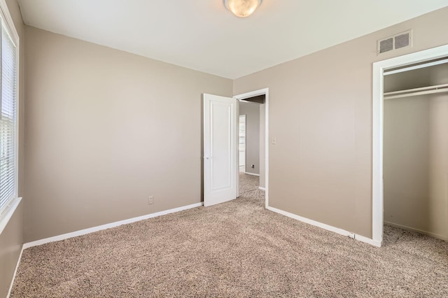 4921 Fremont Ave N, Minneapolis, MN 55430 - unfurnished bedroom featuring carpet floors, multiple windows, and a closet