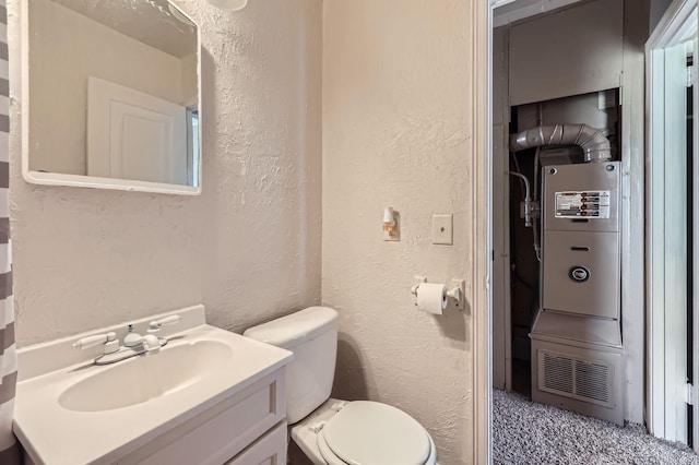 4921 Fremont Ave N, Minneapolis, MN 55430 - half bathroom with a textured wall, vanity, and toilet