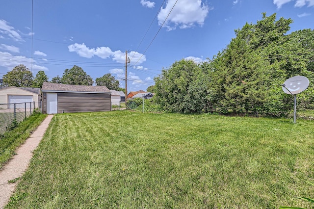 4921 Fremont Ave N, Minneapolis, MN 55430 - view of yard featuring a garage and an outdoor structure