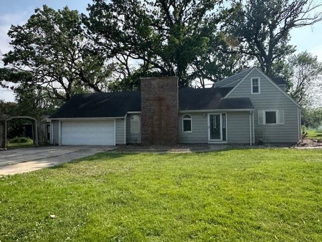 700 Oakland Pl NE, Austin, MN 55912 - view of front facade with a chimney, an attached garage, concrete driveway, and a front yard