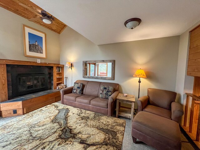 529 Moose Mountain Dr, Lutsen Twp, MN 55615 - carpeted living room with a tiled fireplace, vaulted ceiling, and a ceiling fan