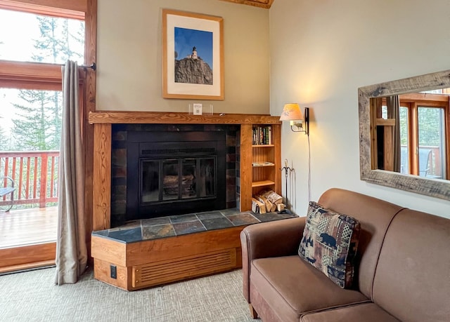 529 Moose Mountain Dr, Lutsen Twp, MN 55615 - carpeted living area with a tile fireplace and plenty of natural light