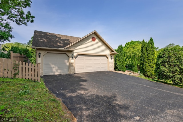 2226 Whispering Trl, Eagan, MN 55122 - view of front of home with asphalt driveway, roof with shingles, a garage, and brick siding
