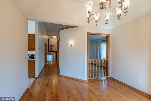2226 Whispering Trl, Eagan, MN 55122 - unfurnished dining area featuring wood finished floors, a chandelier, and baseboards