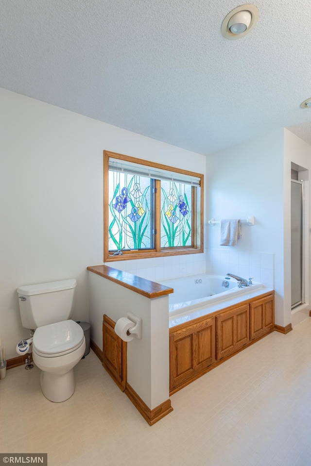 2226 Whispering Trl, Eagan, MN 55122 - bathroom with a bath, a stall shower, toilet, a textured ceiling, and baseboards
