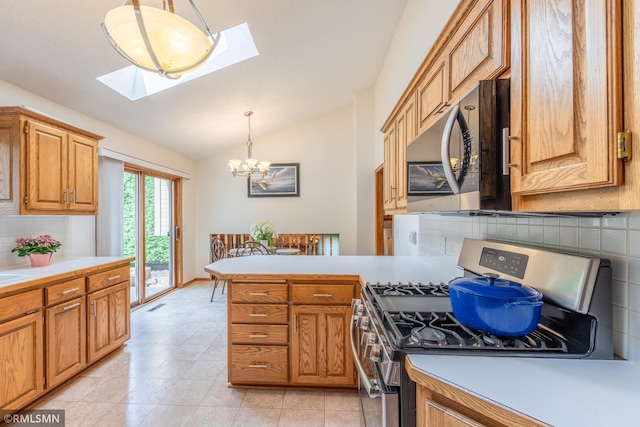 2226 Whispering Trl, Eagan, MN 55122 - kitchen featuring stainless steel gas range, tasteful backsplash, vaulted ceiling, a peninsula, and a chandelier