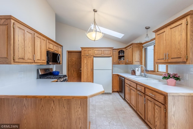 2226 Whispering Trl, Eagan, MN 55122 - kitchen featuring appliances with stainless steel finishes, a skylight, lofted ceiling, decorative backsplash, and light countertops