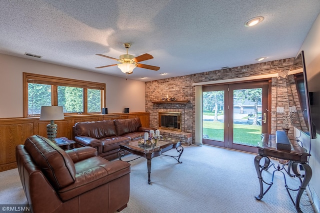 2226 Whispering Trl, Eagan, MN 55122 - carpeted living room with a wainscoted wall, plenty of natural light, a ceiling fan, a textured ceiling, and a brick fireplace