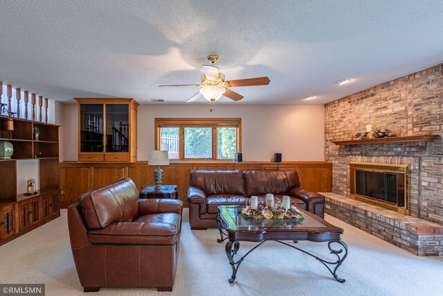 2226 Whispering Trl, Eagan, MN 55122 - carpeted living area featuring a ceiling fan, a wainscoted wall, a textured ceiling, and a fireplace