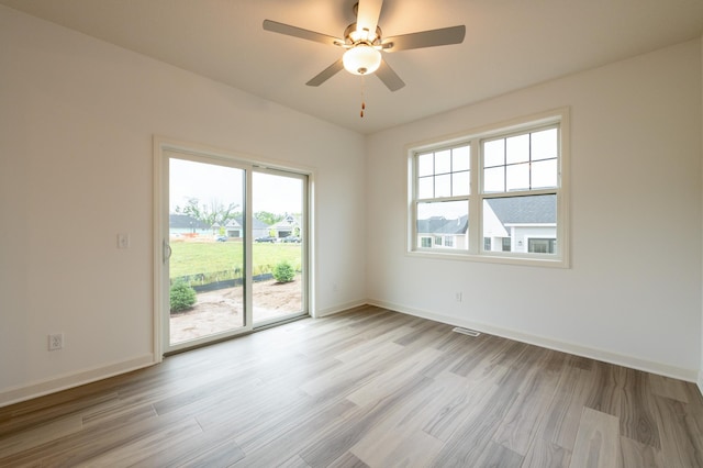 20098 68th Pl, Corcoran, MN 55340 - empty room featuring light wood-type flooring, baseboards, and a ceiling fan