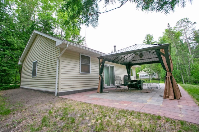 10547 Vermeil Dr NE, Deer River, MN 56636 - rear view of property featuring a gazebo, a patio, and outdoor dining space