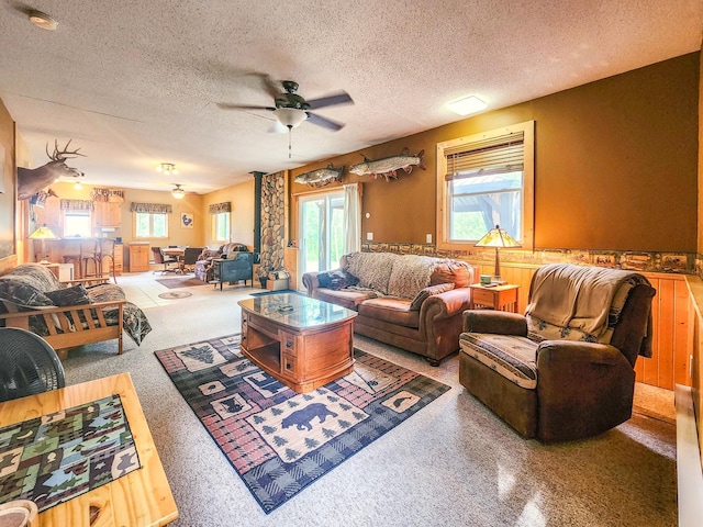 10547 Vermeil Dr NE, Deer River, MN 56636 - living area featuring ceiling fan, healthy amount of natural light, a wainscoted wall, and a textured ceiling