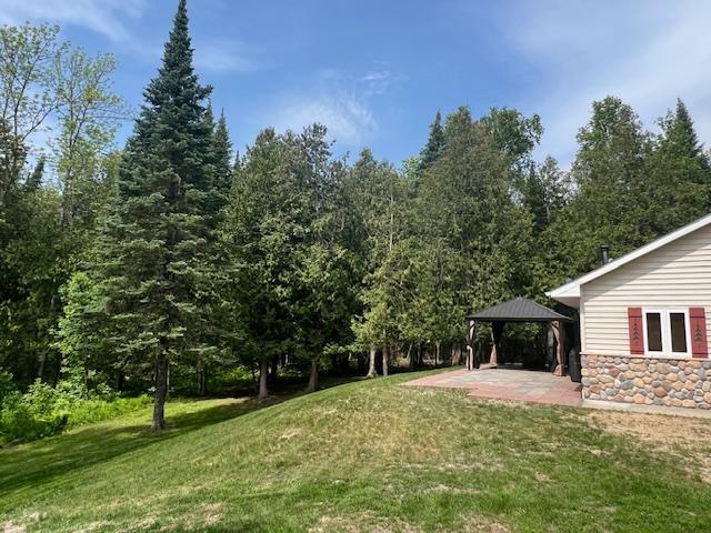10547 Vermeil Dr NE, Deer River, MN 56636 - view of grassy yard with a gazebo and a patio area
