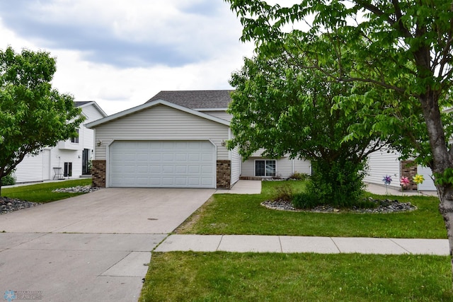 917 11th St W, West Fargo, ND 58078 - view of front of property featuring concrete driveway, a garage, a front yard, and brick siding