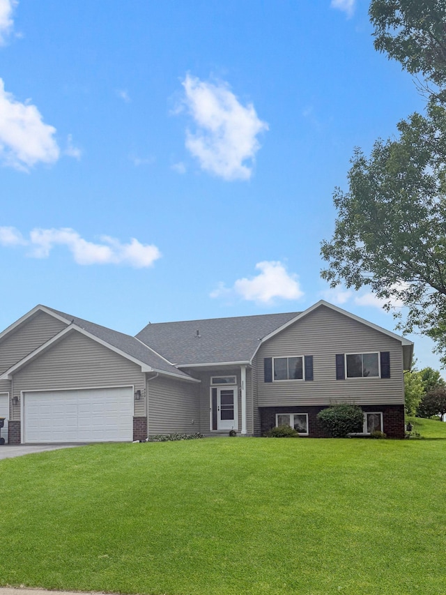 402 Richard Dr, Elko New Market, MN 55054 - split level home with an attached garage, a front lawn, driveway, and brick siding