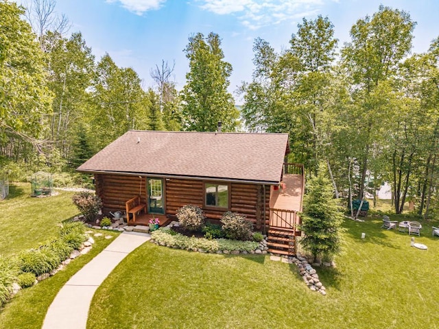 45517 County Road 346, Balsam Twp, MN 55709 - view of front of house featuring log siding, a front lawn, a shingled roof, and covered porch