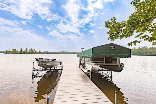 45517 County Road 346, Balsam Twp, MN 55709 - dock featuring boat lift and a water view