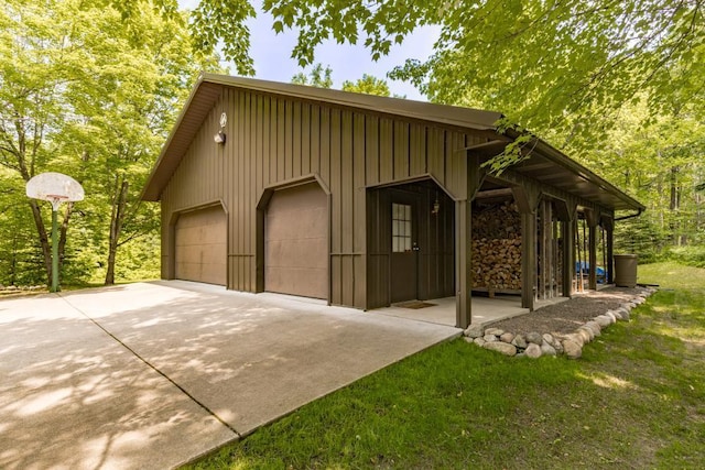 45517 County Road 346, Balsam Twp, MN 55709 - view of front of home with board and batten siding, a detached garage, and an outbuilding