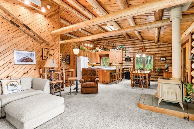 45517 County Road 346, Balsam Twp, MN 55709 - living room featuring a wood ceiling with exposed beams, light carpet, log walls, high vaulted ceiling, and wooden walls