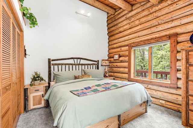 45517 County Road 346, Balsam Twp, MN 55709 - carpeted bedroom featuring log walls and a wooden ceiling with exposed beams