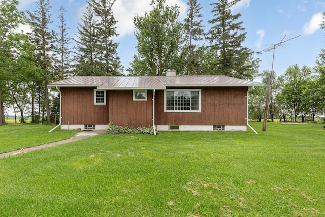 51343 20th Ave, Kenyon Twp, MN 55946 - view of side of home with a metal roof, a lawn, and a chimney