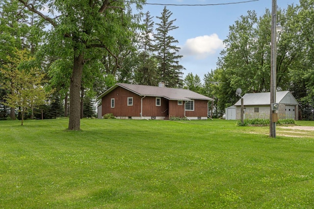 51343 20th Ave, Kenyon Twp, MN 55946 - view of front of home featuring a metal roof, a front lawn, and view of scattered trees