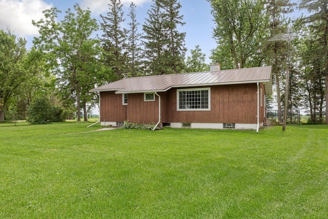51343 20th Ave, Kenyon Twp, MN 55946 - view of property exterior with a chimney, a lawn, and a metal roof