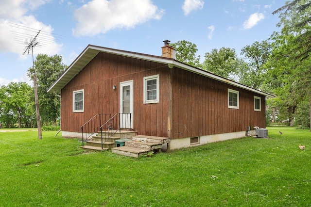 51343 20th Ave, Kenyon Twp, MN 55946 - rear view of house featuring a chimney and a lawn